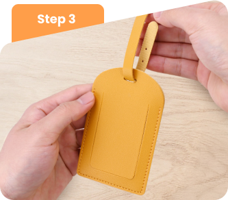 Loop the strap through the luggage tag and secure it. Loop the strap through the luggage tag and secure it.