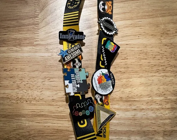 GSJJ IP Lanyards pinned with custom engineer-themed enamel pins, like 'Innovator' and 'Problem Solver'