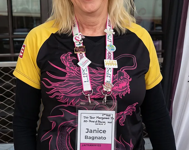 A woman wearing an awareness event lanyard with awareness pins