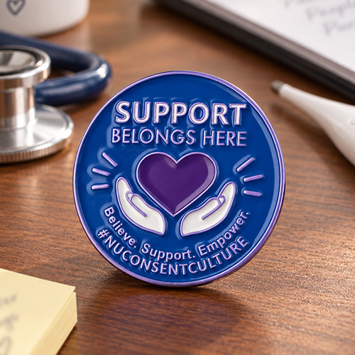 Support Belongs Here round nursing pins with #NUCONSENTCULTURE text